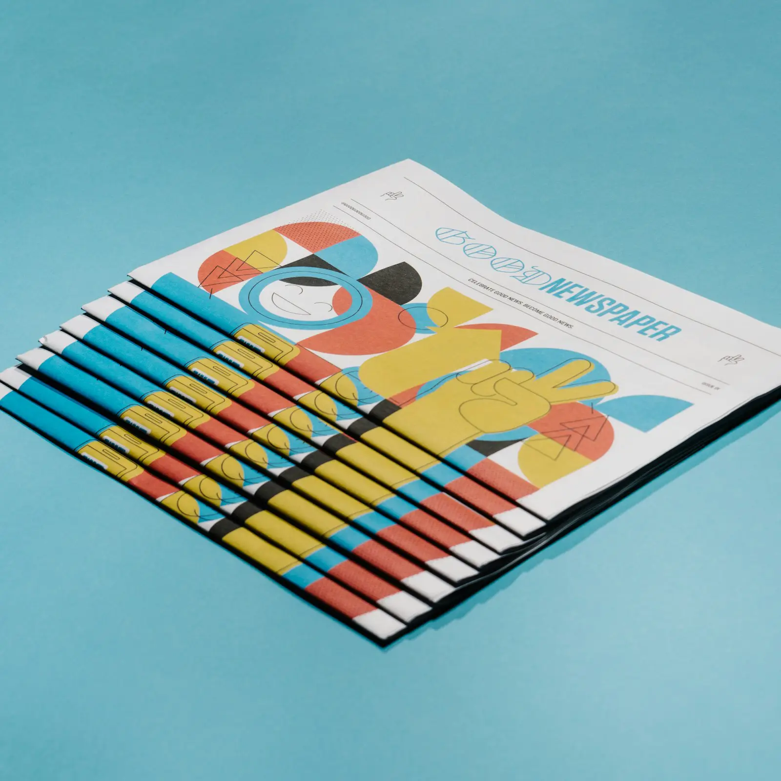 A fanned stack of printed, illustrated brochures