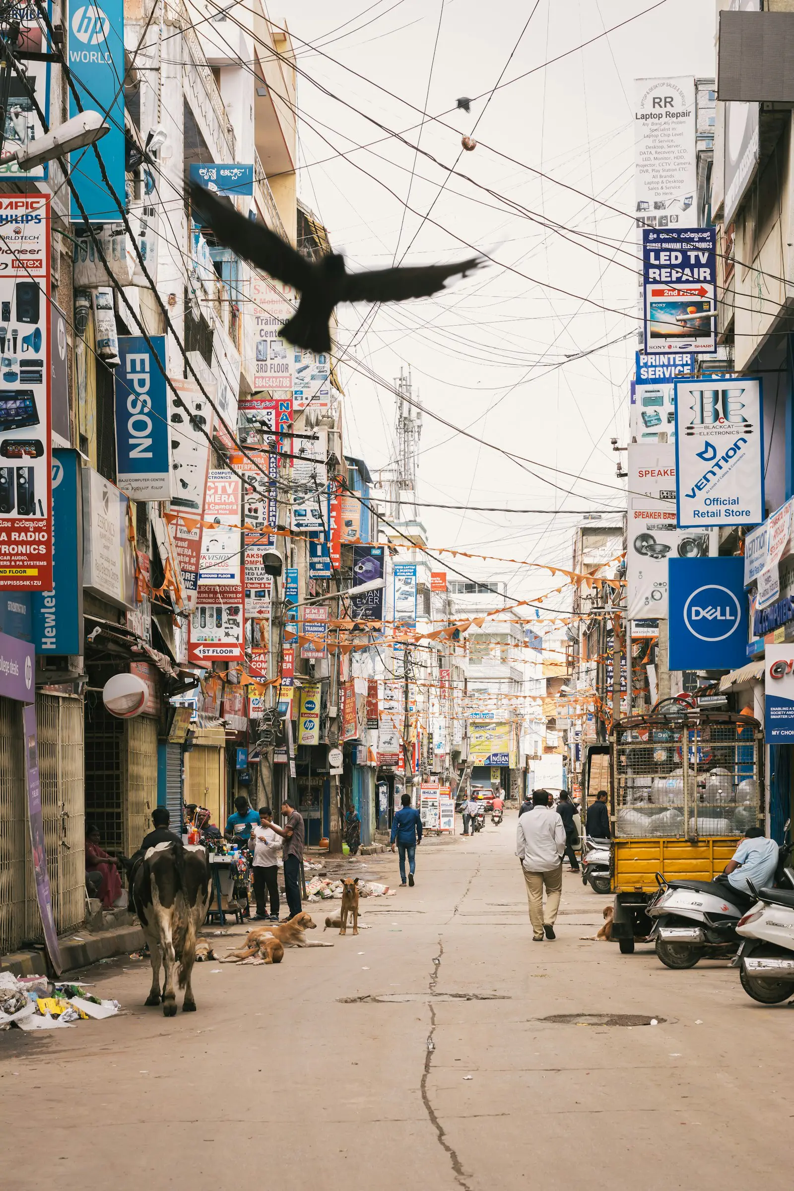 An Indian commercial street lined with brand signboards